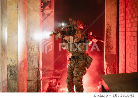 Expert team of soldiers attacking enemy during military operation, Army soldiers in protective combat uniform, Soldiers with rifle on world war field 105181643