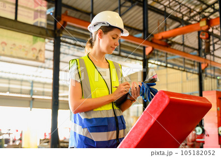 Mechanical engineers repairing engine machine at factory 105182052