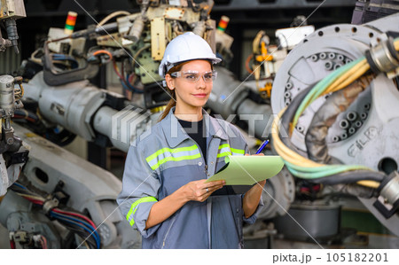 Female engineer worker working with robotic machine automation 105182201