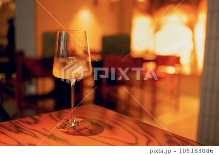 One delicious ice cold cocktail in exquisite glasses stand on a wooden table in a restaurant. One delicious ice cold cocktail in exquisite glasses stand on a wooden table in a restaurant. 105183086