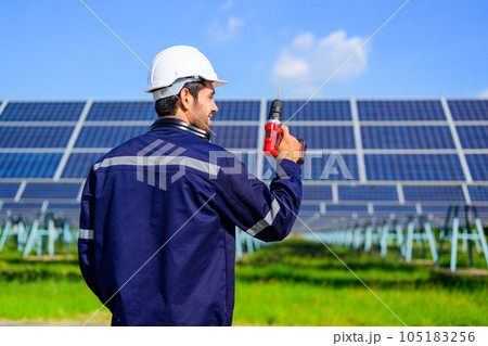 Engineer worker portrait with solar panel at solar farm 105183256