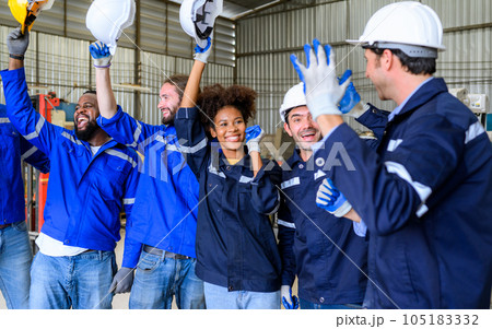 Group of happy engineers workers team smiling and standing at factory 105183332