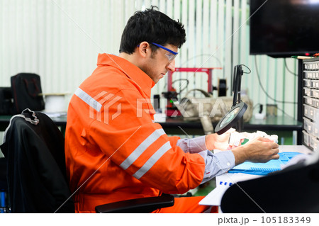 Engineer with safety uniform working and repairing machine 105183349