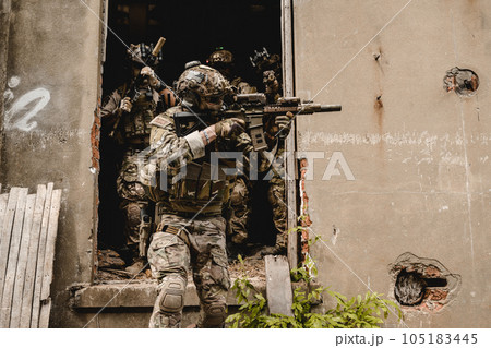 Expert team of soldiers attacking enemy during military operation 105183445