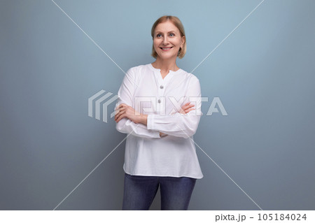 healthy slim blond mature woman smiling on studio background 105184024