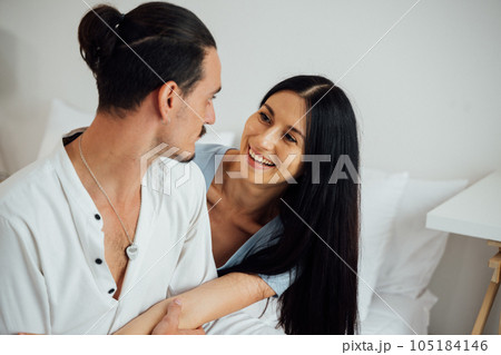 Happy young couple of husband and wife spending time together at home, People relaxing and resting at modern house, Family and lovers lifestyle 105184146