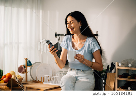 Happy young woman spending time at home, People relaxing and resting at modern house, People lifestyle, Beautiful woman sitting indoor at home 105184193