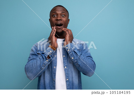 young joyful with dark skin american guy dressed stylishly in jeans isolated studio background young joyful with dark skin american guy dressed stylishly in jeans isolated studio background 105184195