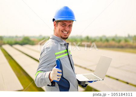Maintenance technician working on ecological solar cell farm 105184311