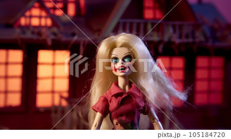 creepy doll at night against the backdrop of a scary house 105184720
