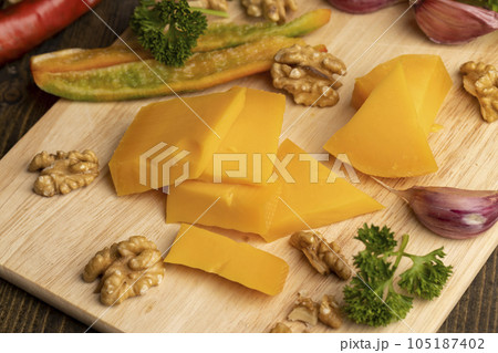 Sliced hard cheese made from milk 105187402