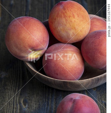 Ripe fresh peaches on a wooden table Ripe fresh peaches on a wooden table 105187444