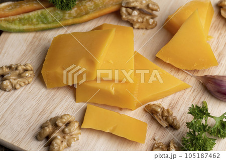 Sliced hard cheese made from milk Sliced hard cheese made from milk 105187462
