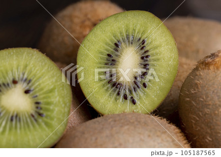 A group of cut green kiwi fruits with black seeds A group of cut green kiwi fruits with black seeds 105187565