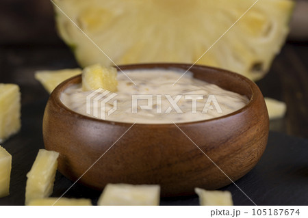 milk pineapple yogurt with pieces of pineapple and other fruits milk pineapple yogurt with pieces of pineapple and other fruits 105187674