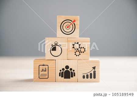 Wooden block cude step on table with Action Plan, Goal, and Target icons. Success and business target concept. Project management and company strategy symbolize growth. Wooden block cude step on table with Action Plan, Goal, and Target icons. Success and business target concept. Project management and company strategy symbolize growth. 105189549