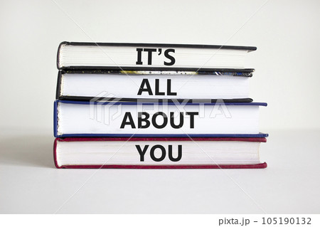It is all about you symbol. Books with words 'It is all about you'. Beautiful white background. Businessman hand. Copy space. Business and it is all about you concept. 105190132