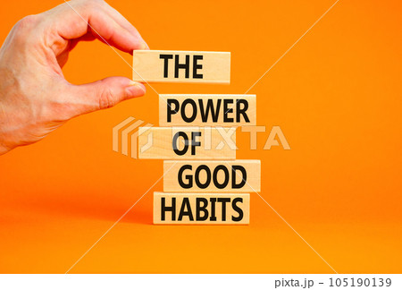 The power of good habits symbol. Concept words The power of good habits on wooden block. Beautiful orange table orange background. Businessman hand. Business power of good habits concept. Copy space. 105190139