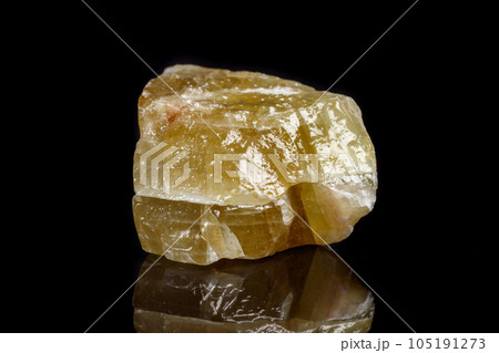 Macro mineral stone yellow Calcite on a black background 105191273