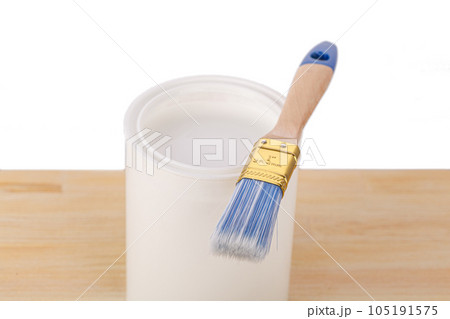 white paint with a brush on a wooden background with texture 105191575