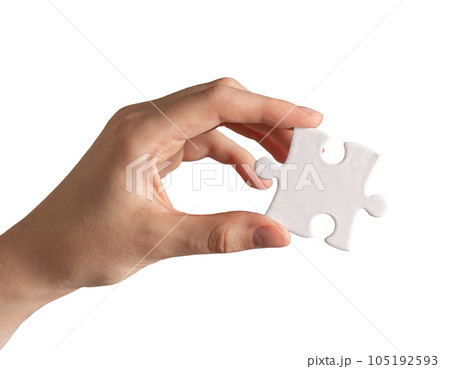 Hand holding single piece of puzzle isolated on white background Hand holding single piece of puzzle isolated on white background 105192593