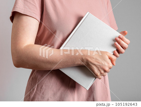 Hand holding book, abstract study literature 105192643
