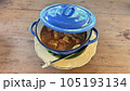 Thai style curry with fired egg in blue pot on wooden table. 105193134