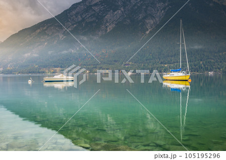 Sailboats on Achensee lake near Innsbruck at peaceful dawn, Tyrol alps, Austria 105195296