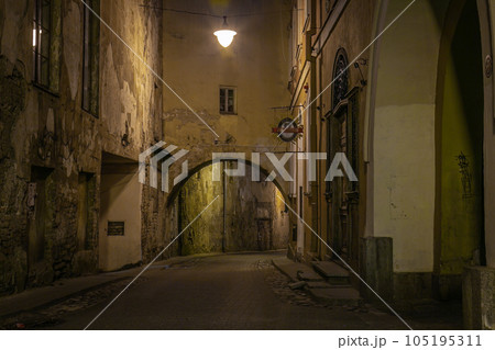 Vilnius old town street illuminated at night, Lithuania, Baltics Vilnius old town street illuminated at night, Lithuania, Baltics 105195311