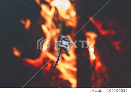 Marshmellows with Halloween pictures over fire. Funny leisure on traditional spooky holiday for children and families. 105196052