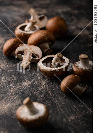 Raw champignon mushrooms on black background Raw champignon mushrooms on black background 105198693