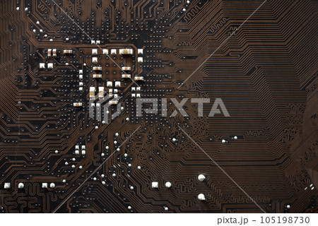 Brown electronic board with trace elements. Radio elements on the board. Brown electronic board with trace elements. Radio elements on the board. 105198730