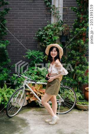 Happy youth asian woman with camera travels street city trip on leisure weekend. Young hipster female tourist sightseeing summer urban Bangkok destination. Asia summer tourism concept. 105199159