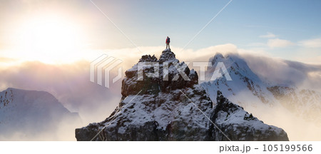 Adventurous Man Standing on top of Mountain Cliff. Dramatic Extreme Adventure Composite Adventurous Man Standing on top of Mountain Cliff. Dramatic Extreme Adventure Composite 105199566