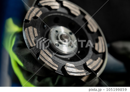 Craftsman holding a grinder with a diamond bowl. Craftsman holding a grinder with a diamond bowl. 105199859