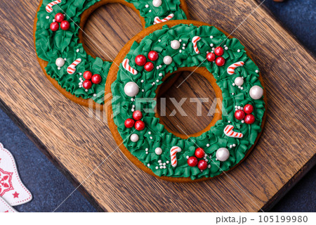 Beautiful festive Christmas gingerbread made by hand with decoration elements Beautiful festive Christmas gingerbread made by hand with decoration elements 105199980