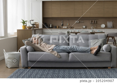 Calm sleepy mature lady lying on sofa with closed eyes Calm sleepy mature lady lying on sofa with closed eyes 105204987