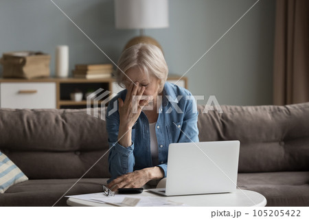 Upset retired female frustrated by lack of finances 105205422