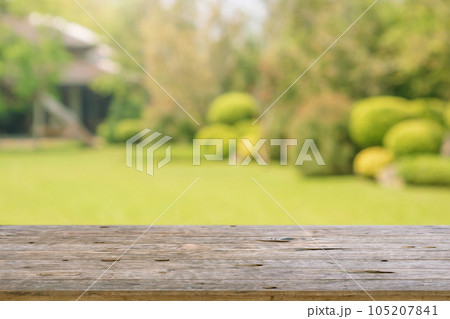 Empty wood table top with abstract blur park garden background 105207841