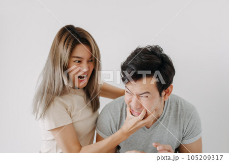 Domestic violence of wife hitting husband isolated on white. Domestic violence of wife hitting husband isolated on white. 105209317