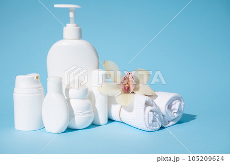 Intimate hygiene gel in white bottle with dispenser and small mockup bottles with beauty products for skin and body care 105209624