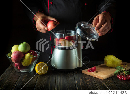 The chef adds a sliced apple to the blender for a sweet fruit drink. Healthy Vegetarian Breakfast or Dinner Idea 105214428