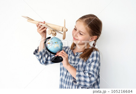 preteen photo Preteen girl holding globe and wooden plane as...の写真素材 [105216684] - PIXTA