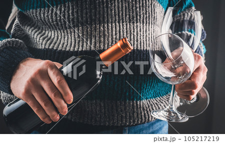 Man holding wine bottle and glasses Man holding wine bottle and glasses 105217219