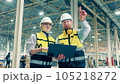 Two factory specialists are smiling while making plans 105218272