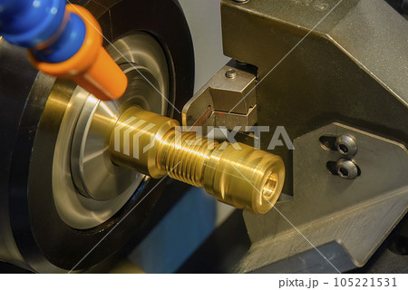 Close up scene the CNC lathe machine slot cutting at the end of brass pipe coupling parts. 105221531