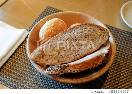 Slices of bread served in a basket on the table Slices of bread served in a basket on the table 105224197