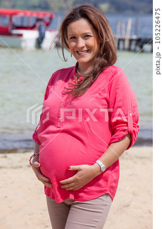 Portrait of a young woman waiting for her baby at the beautiful white beach of Lake Tota located in the department of Boyaca at 3,015 meters above sea level in Colombia 105226475