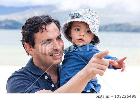 Young father having fun with his baby girl at the beautiful white beach of Lake Tota located in the department of Boyaca at 3,015 meters above sea level in Colombia Young father having fun with his baby girl at the beautiful white beach of Lake Tota located in the department of Boyaca at 3,015 meters above sea level in Colombia 105226499