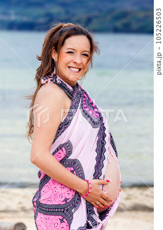 Portrait of a young woman waiting for her baby at the beautiful white beach of Lake Tota located in the department of Boyaca at 3,015 meters above sea level in Colombia 105226503